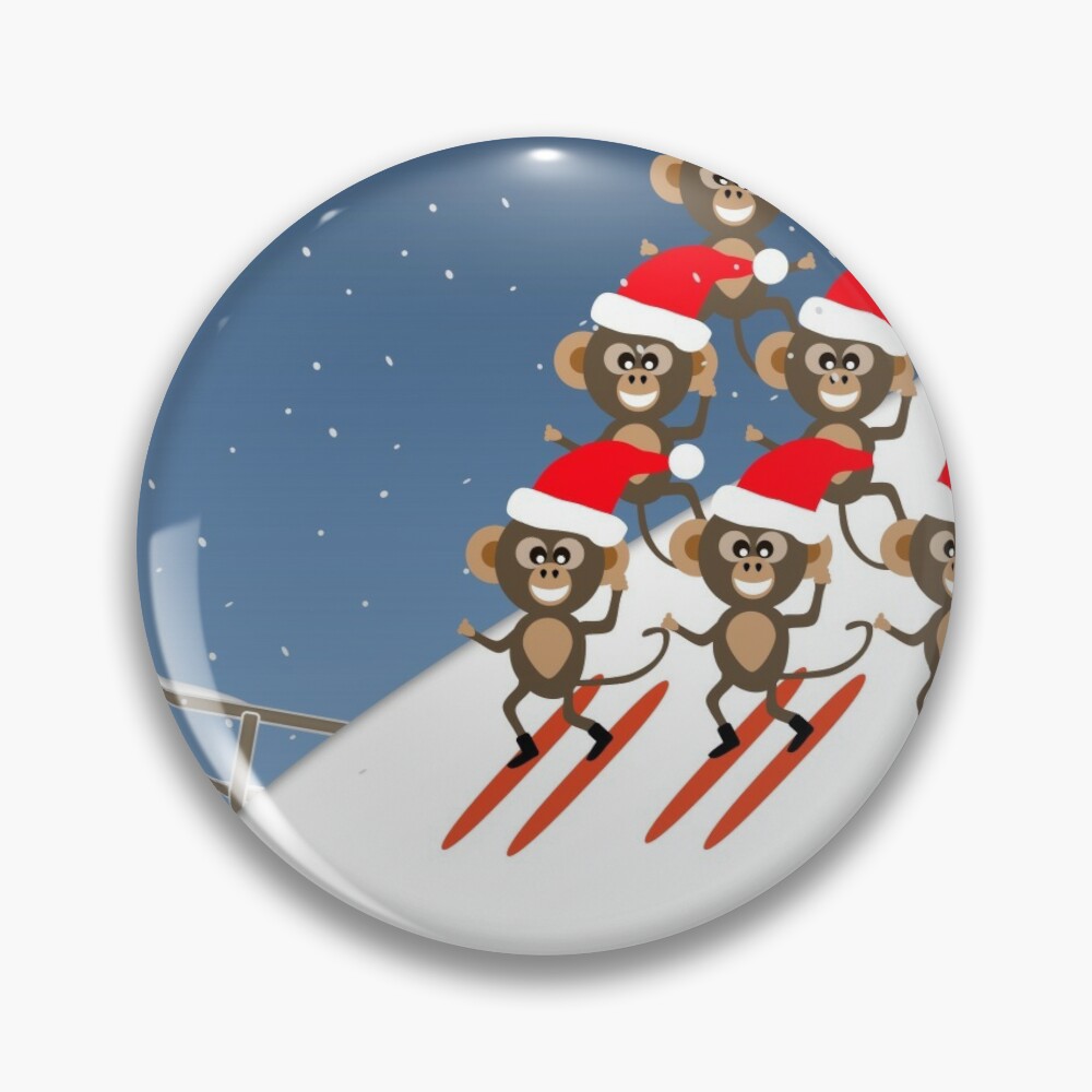 Chibi chimp monkeys skiing down a mountain with Santa hats at Xmas pin badge